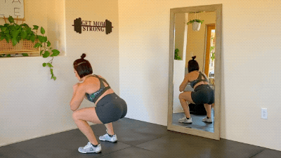 Ashley doing a bodyweight squat exercise for pelvic floor health
